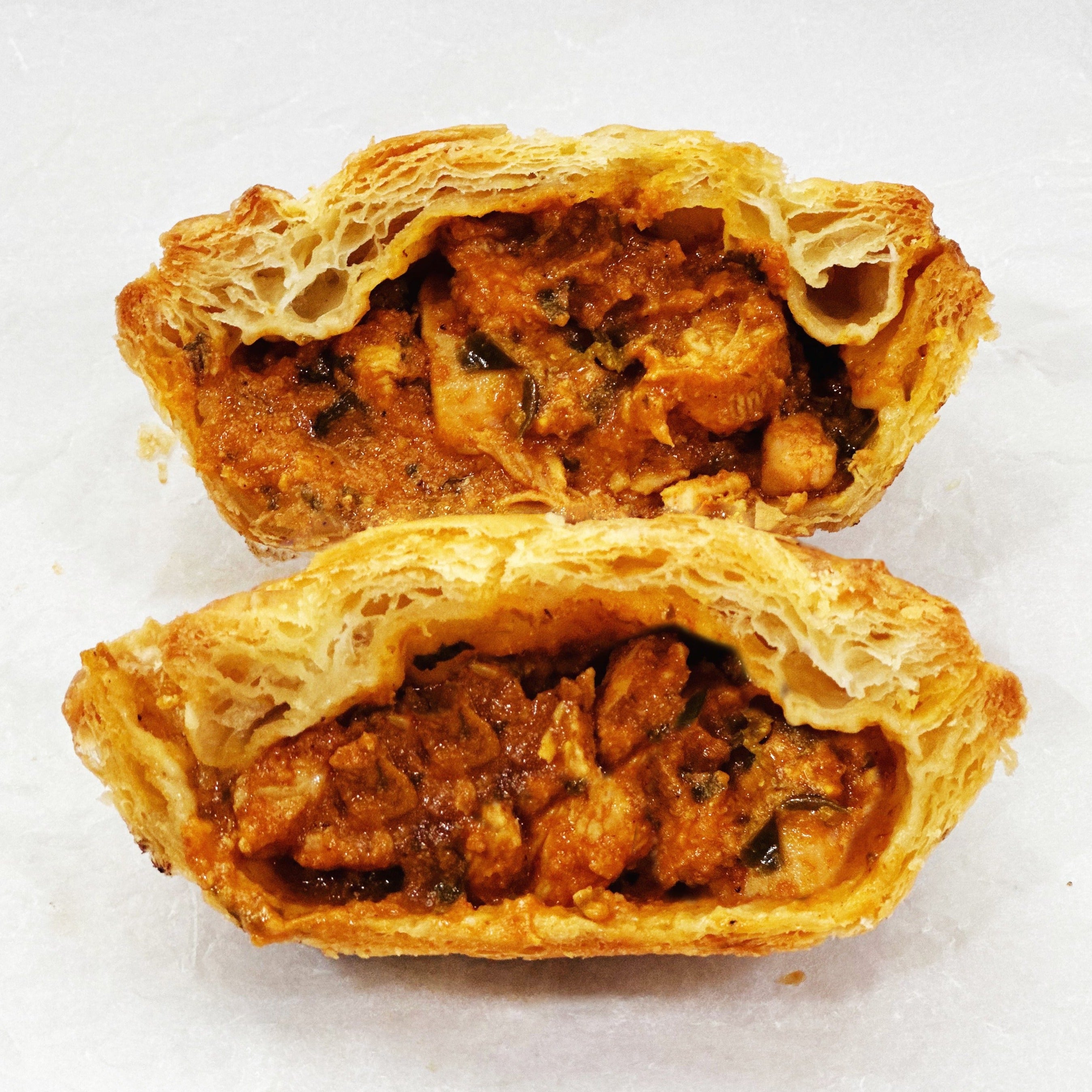 Indian butter chicken pot pie with creamy spiced sauce and puff pastry crust