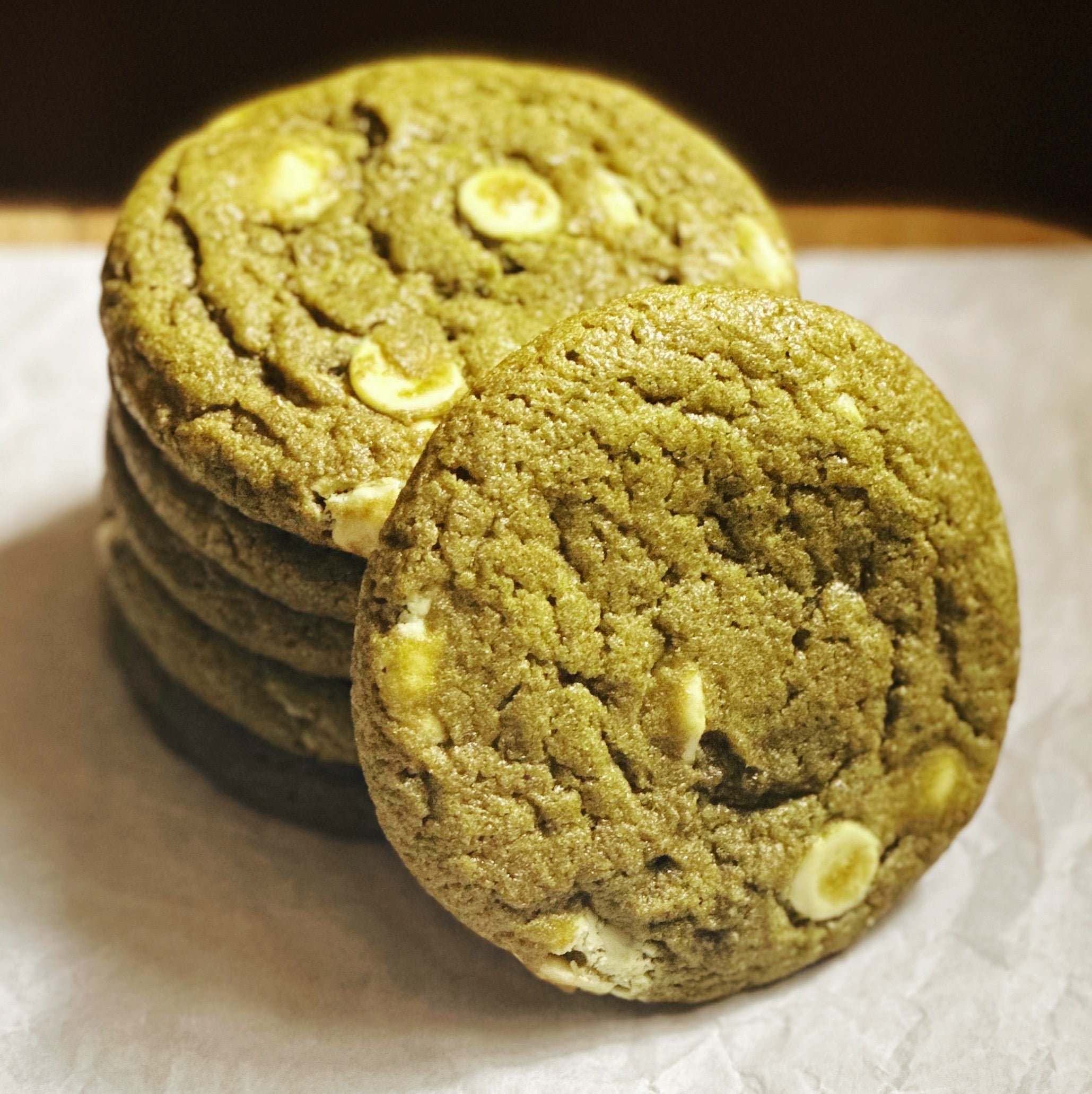 A stack of 6 baked matcha white chocolate chip cookie dough