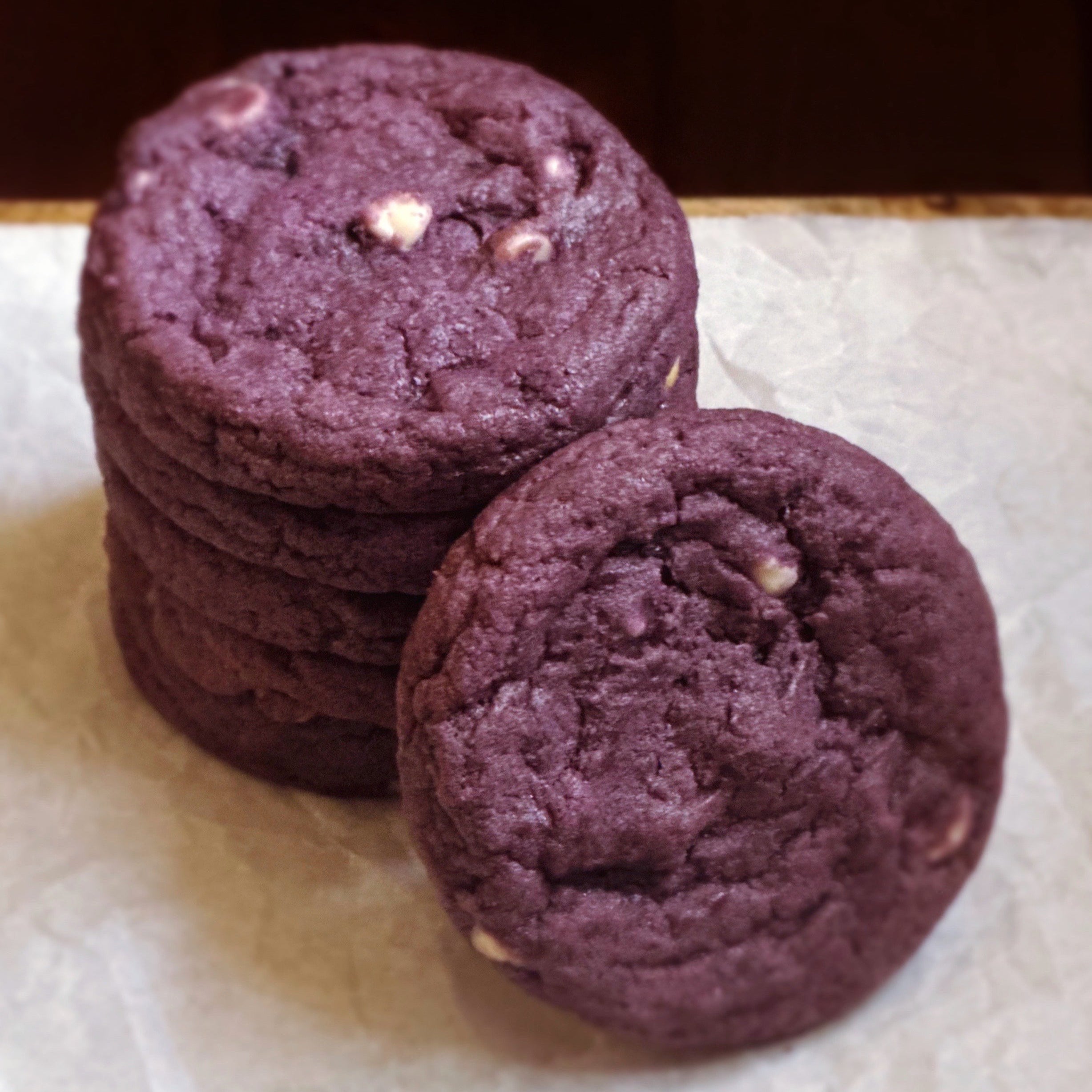 A stack of 6 baked taro ube white chocolate chip cookie dough