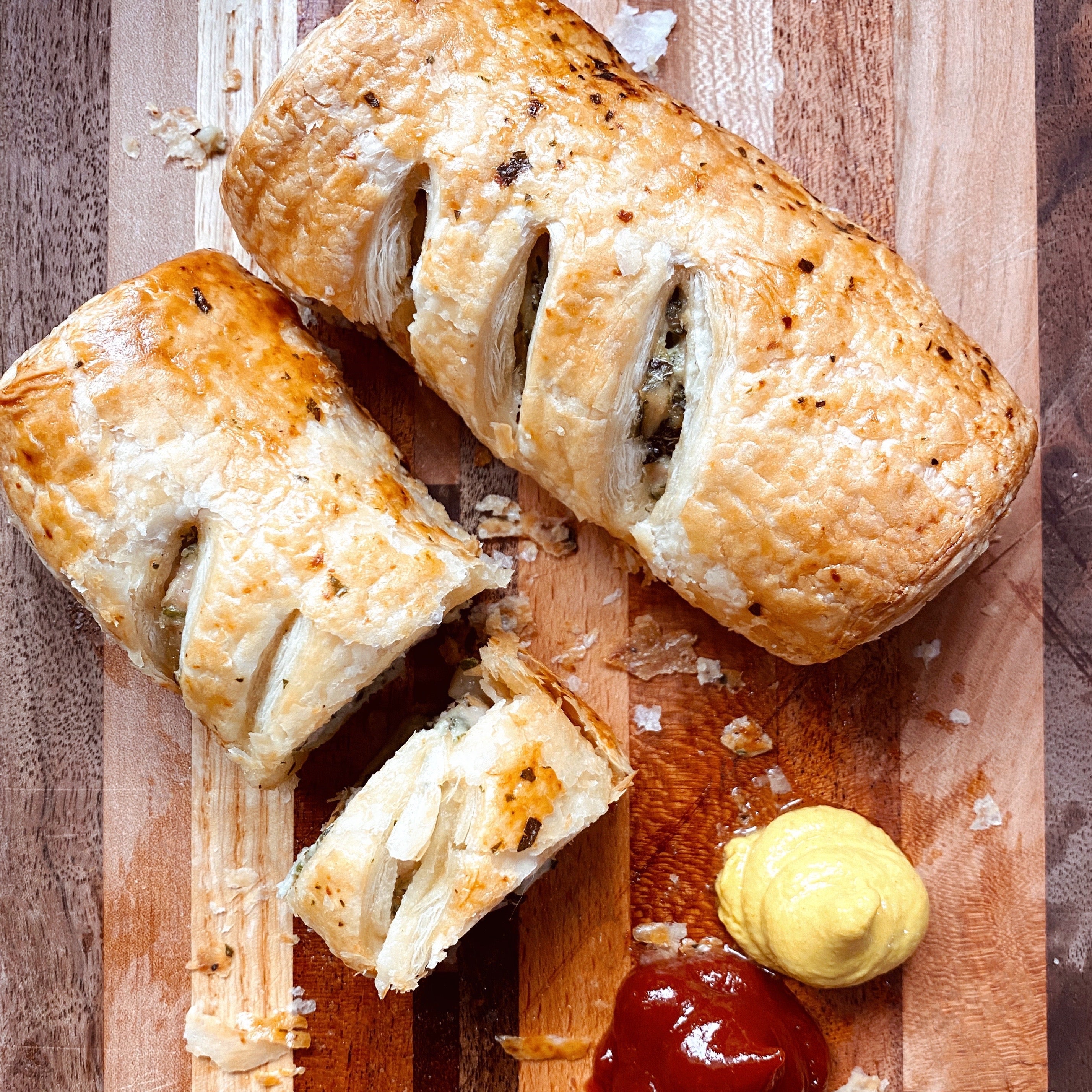 Bake-at-home pigs-in-a-blanket with flaky puff pastry. Comes in pork breakfast sausage, or cheesy chicken/turkey sausage