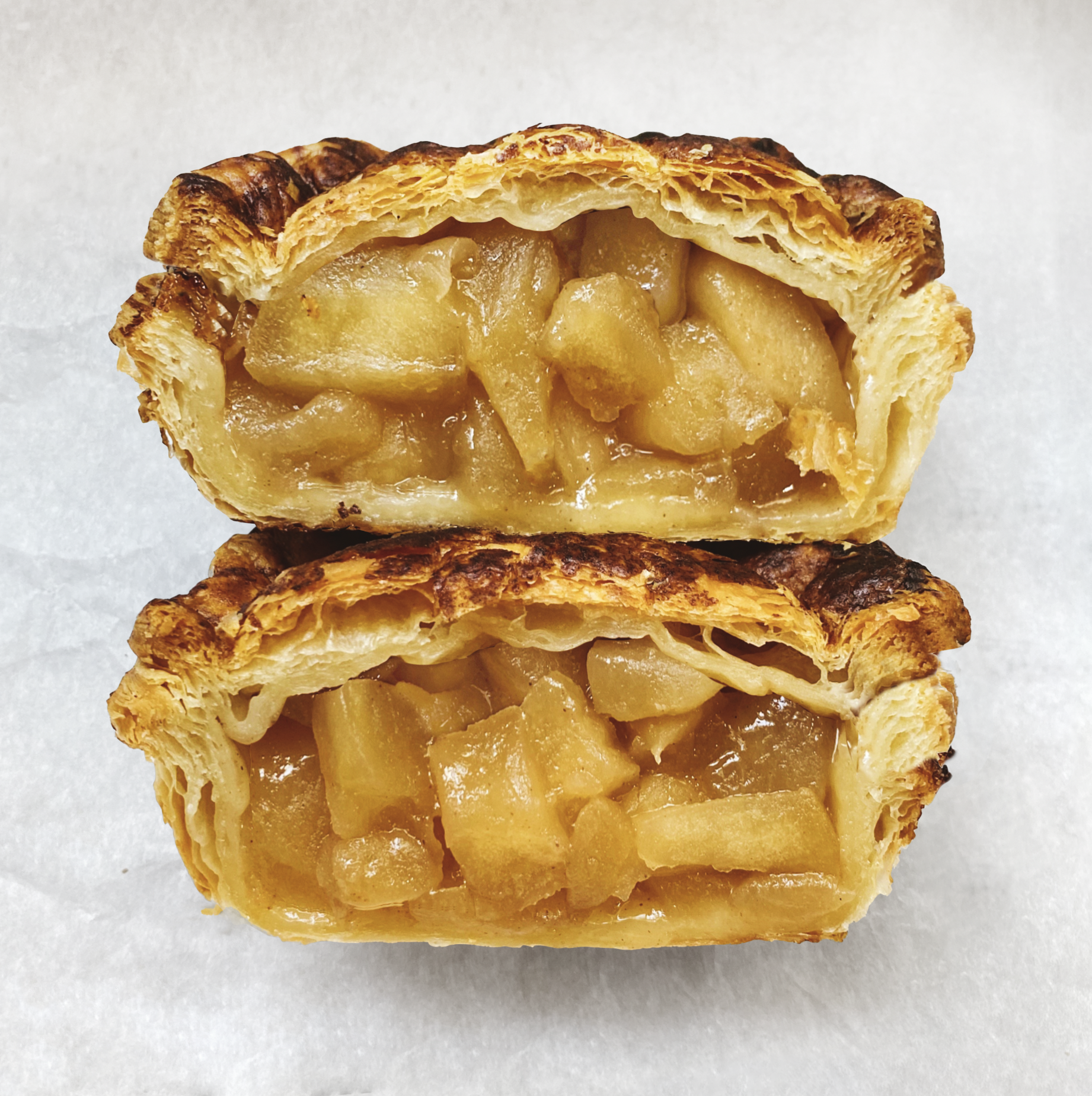 Vegan apple pie filled with cinnamon-spiced honeycrisp apples and a puff pastry crust