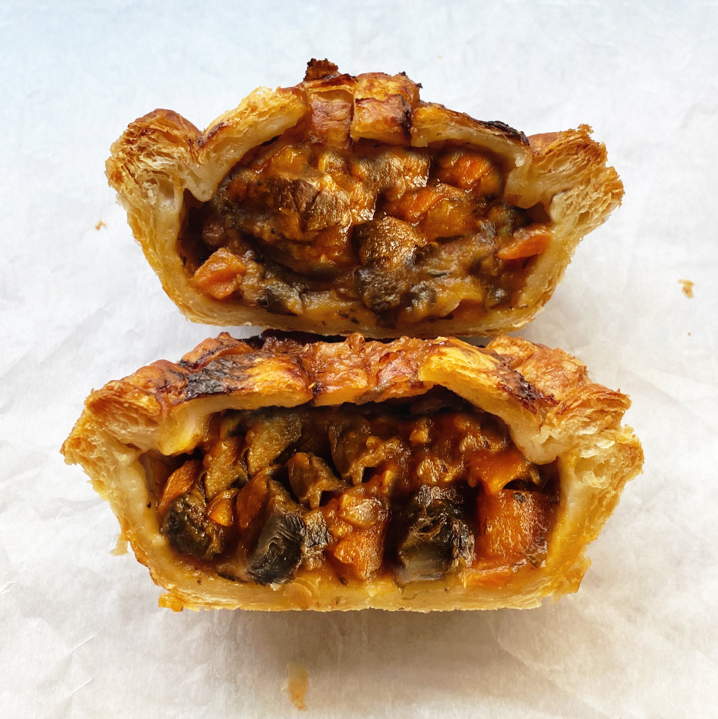 Vegan pot pie with a blend of crimini, portobello, and oyster mushrooms in a crisp puff pastry shell