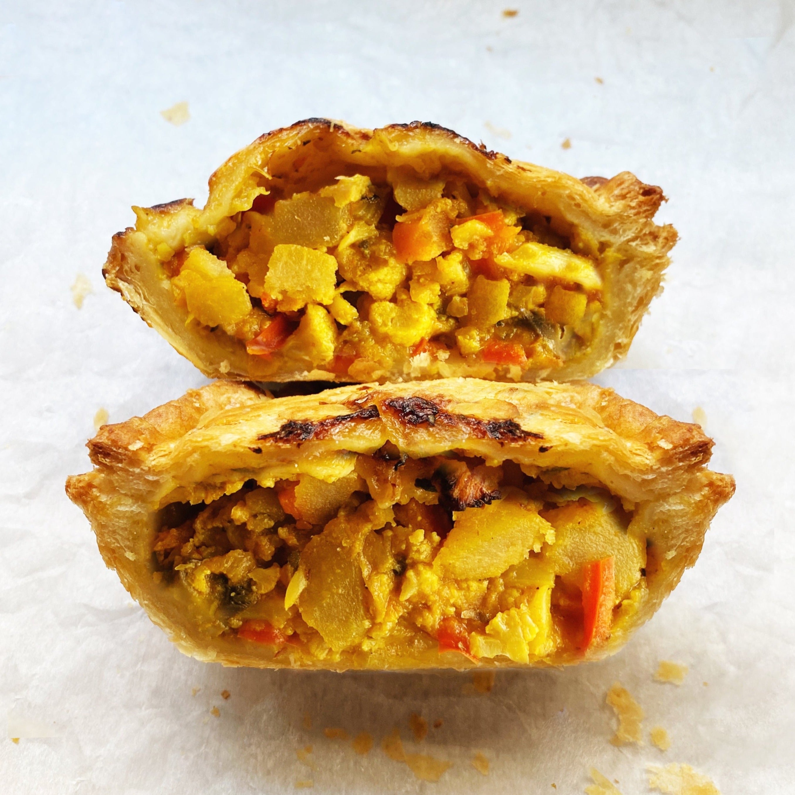 Vegan vegetable curry pot pie wrapped in golden flaky puff pastry