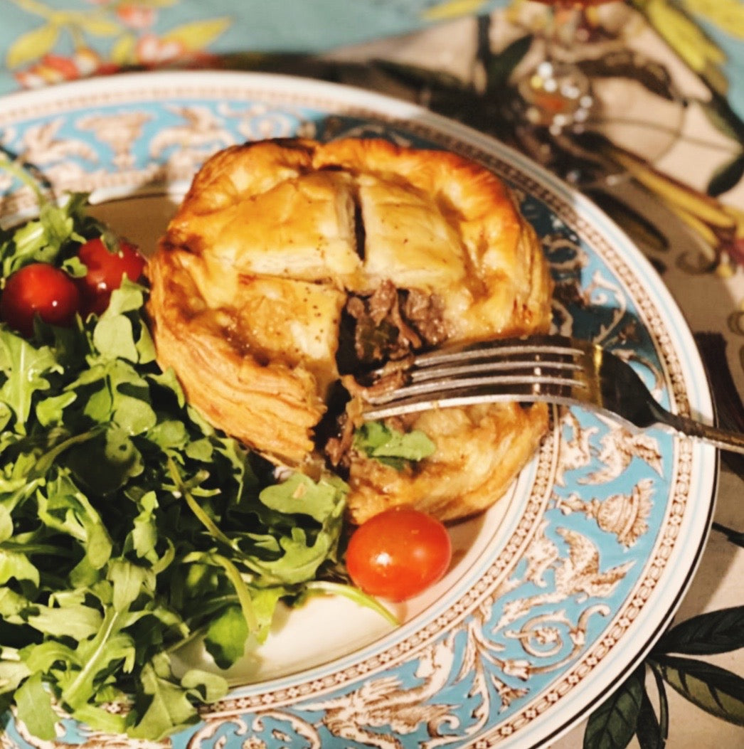 Customer photo of Guinness Steak Pie served with a fresh arugula and tomato salad