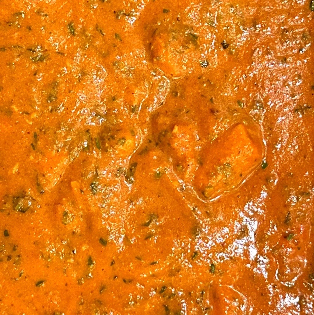 Close up of a bake-at-home Indian butter chicken pie filling