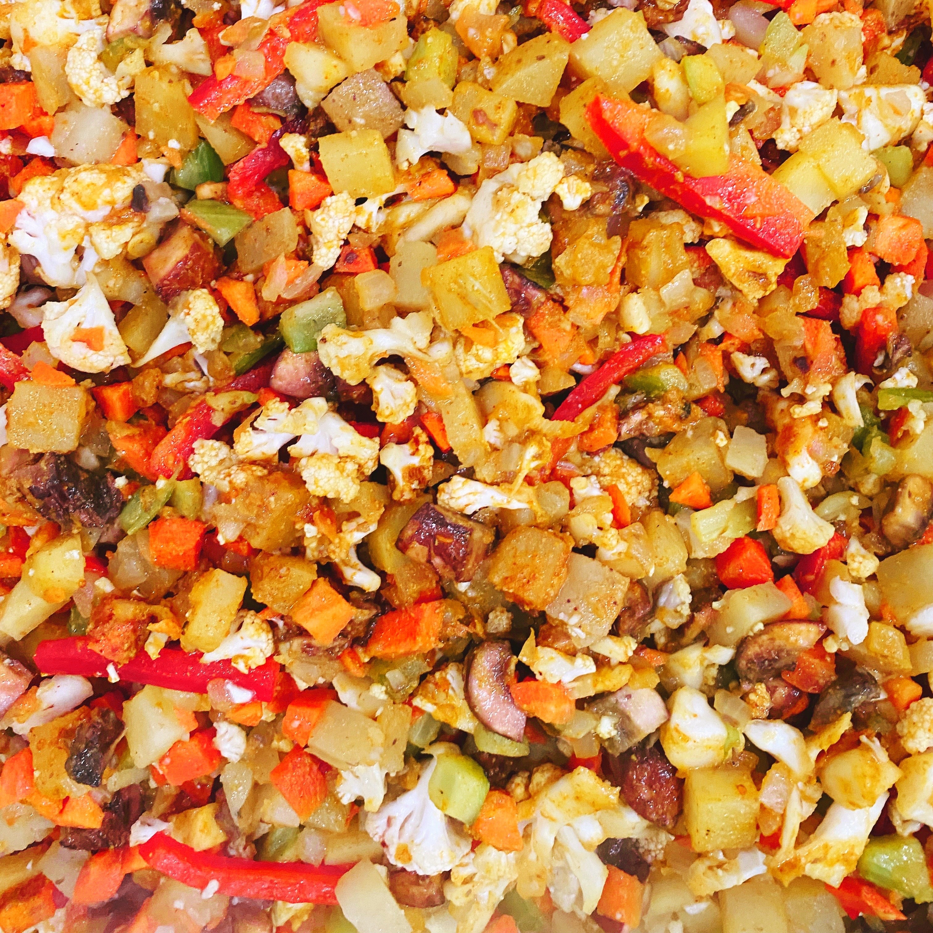 Close-up of the Veggie Curry Pie filling with a variety of vegetables cooked in a yellow curry